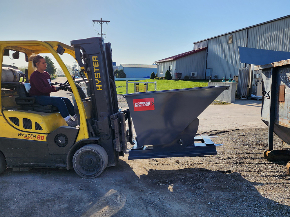 Backed By Generational Experience_ a forklift carrying a chip hopper